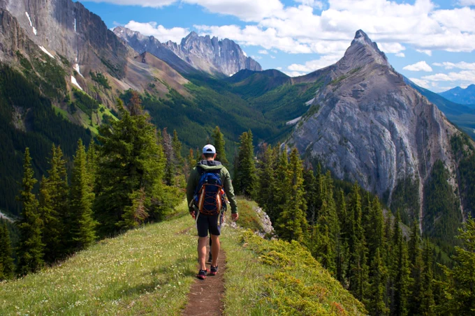 A man hiking on a mountainous trail.