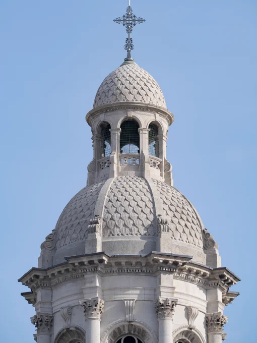 Close-up view of the ornate dome and bell tower (Campanile) of Trinity College Library against a clear sky.
