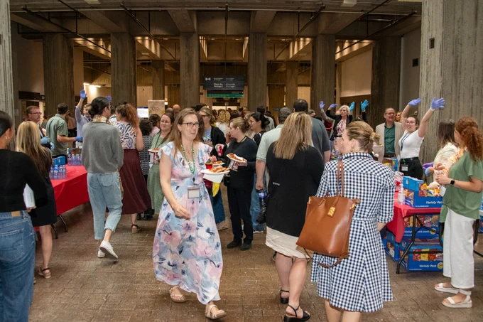 A photo showing many people indoors, enjoying the National Public Service Week event. 