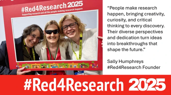 Three females smiling looking at the camera with a board saying #Red4Research supporting research and all the people making research happen