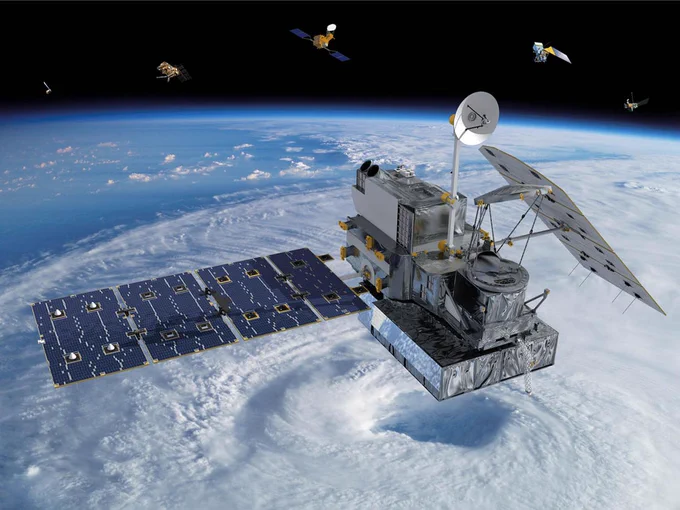The GPM Core Observatory satellite in space above Earth, passing over a large hurricane. 