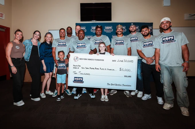 The Yankees present a check to the non-profit NY Metro Black Pilots of America during HOPE Week. 
