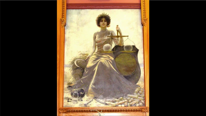 Painting titled "Spirit of Kansas," depicting a person holding scales, set against a backdrop of light. The frame is ornate.