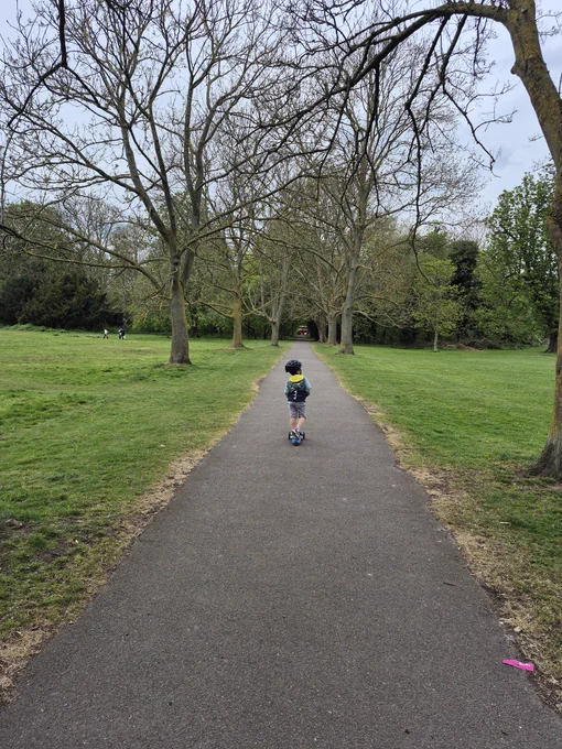 A photo of a little boy on a scooter