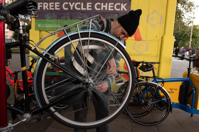 Dr Bike mechanic fixing a bicycle.