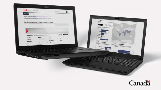 Two black laptops are displayed against a white background. The laptop on the left shows a webpage titled “DevData Dashboard Global Affairs Canada” with various text and data tables. The laptop on the right displays a webpage with graphs and a world map, indicating data visualization. In the bottom right corner of the image, there is a white Canada wordmark with a red maple leaf. 