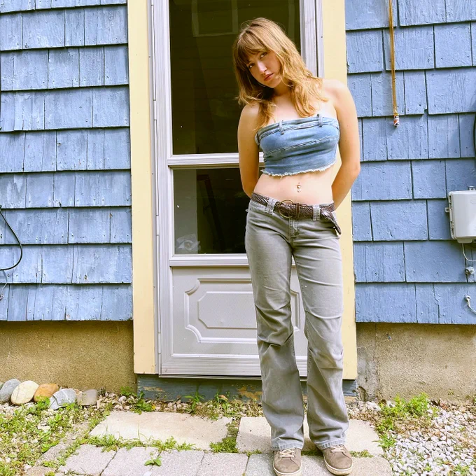 Maddy Ringo standing in front of a blue house.