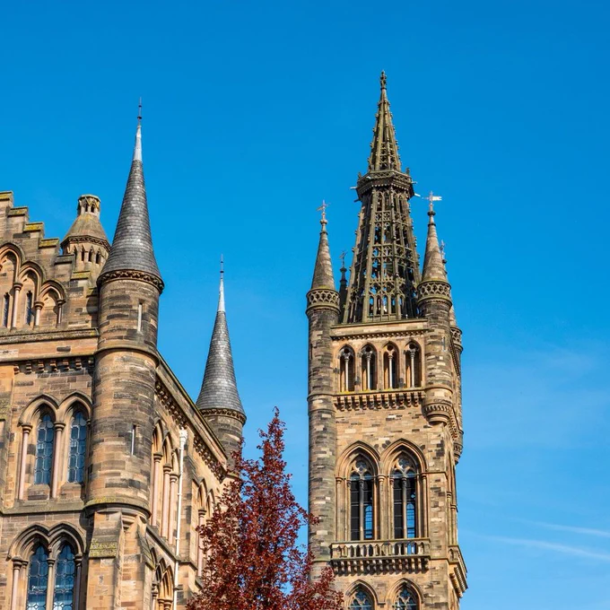 The Gilbert Scott Building and Tower with sunny blue skies in the background. 