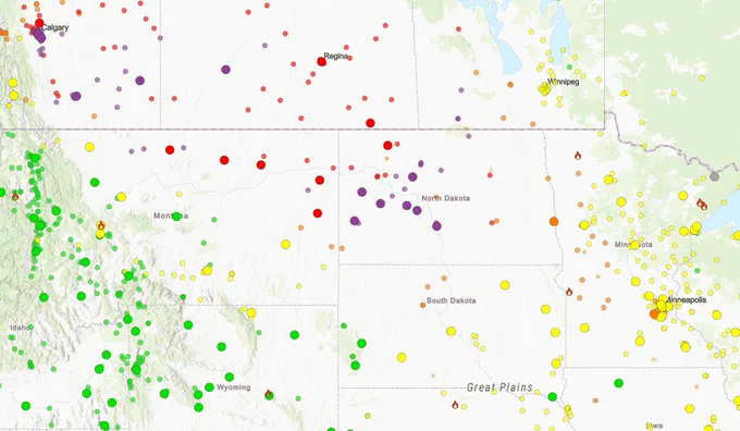 AirNow Fire and Smoke Map at 8:45 a.m. EST on June 11, 2025. Code Purples and Red in Montana and North Dakota, surrounded by code oranges and yellows in the upper Midwest and northern great plains.