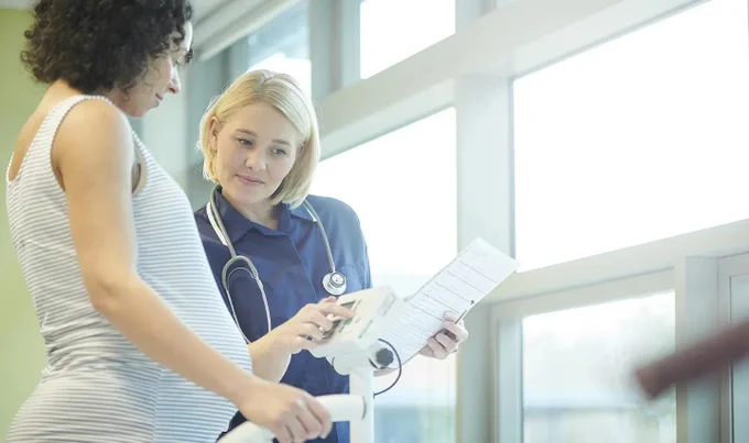 Pregnant woman talking with healthcare professional