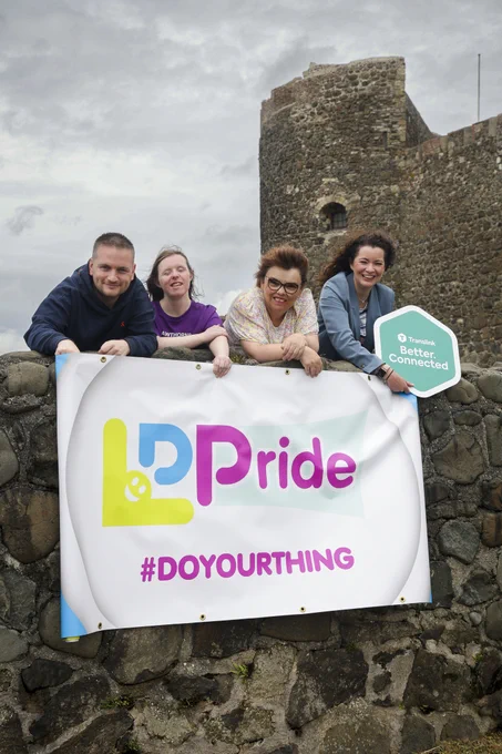 Group shot outside Carrick Castle with a Learning Disability Pride banner