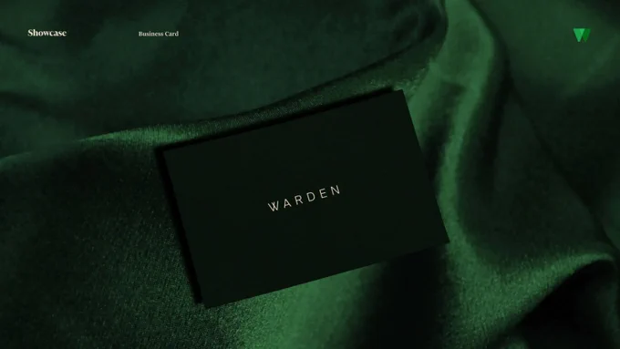 Warden: Photo of a matte-black business card stamped ‘WARDEN’ in small silver type, resting on folded deep-green velvet; minimalist branding showcase.