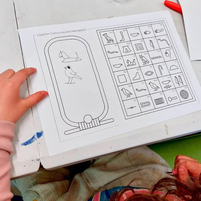 Photograph of hieroglyphics activity sheet and scarab beetle craft. 