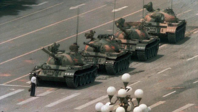 Famous picture of a man standing in front of a line of tanks in Tiananmen Square in 1989.