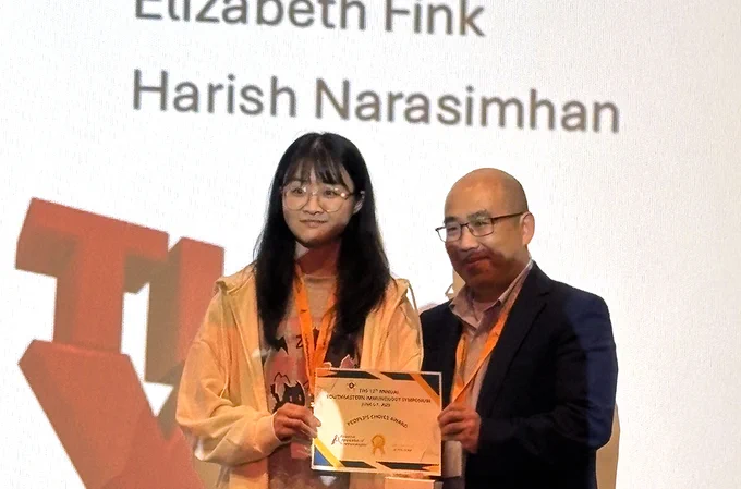 Woman and man with award