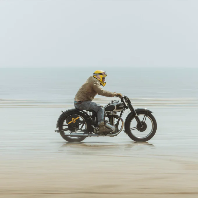 A man racing across Bridlington's south beach on a vintage motorcycle