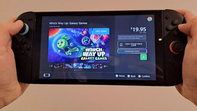 A Nintendo Switch 2 in handheld mode with two hands holding it