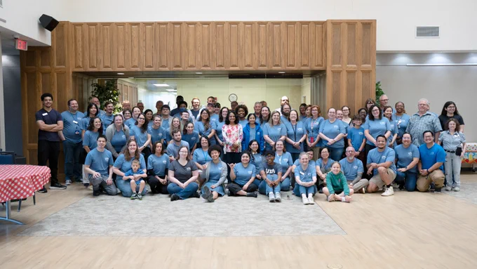[ID: Pictured is a group photo of the UTA Libraries staff taken at the staff family picnic on June 11.]