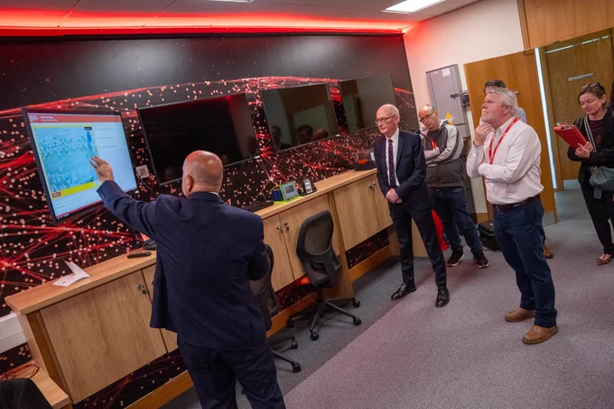 Image shows Queen's staff showing the Minister some of the facilities.