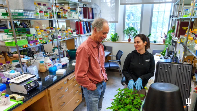 Roger Innes discusses work on soybean plants with one of the postdocs in a lab.  