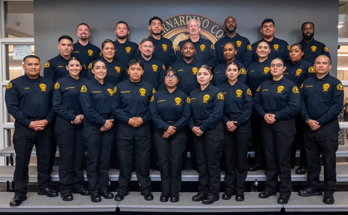A group of officers smiling and posing for a group photo.