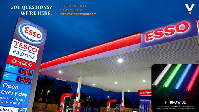 A brightly lit Esso forecourt at night, showcasing Visive’s Hi-Brow™30 LED wall-wash contour tube lighting. The canopy features a smooth, even glow created by the frosted acrylic Hi-Brow™30 tubes, available in vibrant colors like red, blue, green, and white—designed to deliver a consistent, professional fascia illumination.