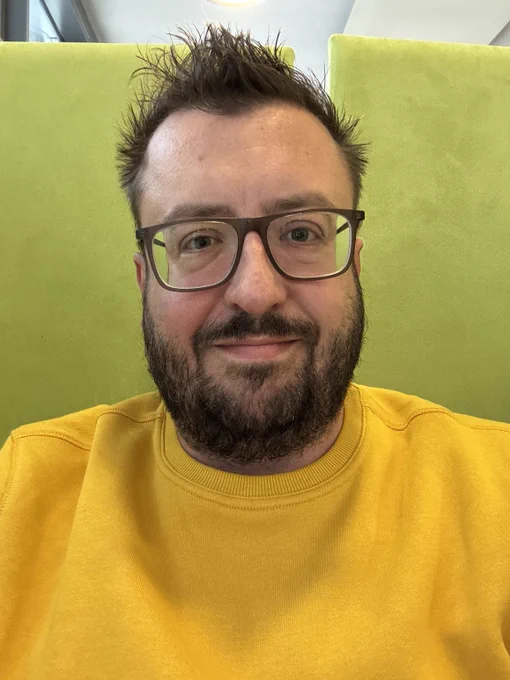 Dan wearing a yellow jumper.