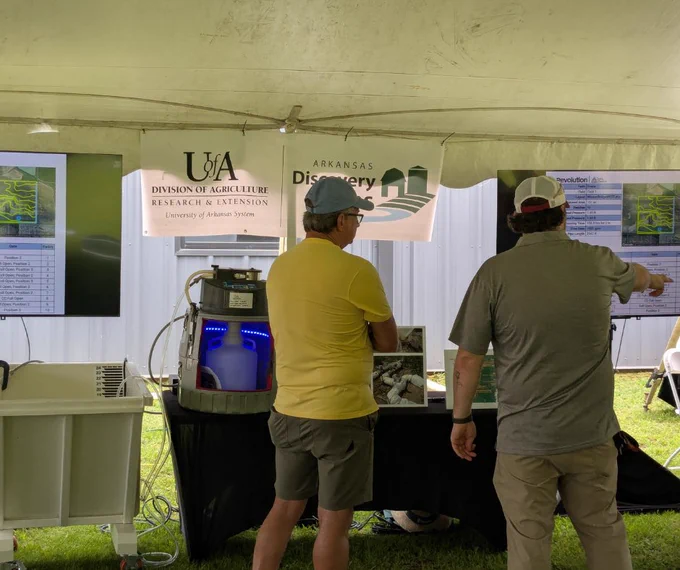 Arkansas Discovery Farms team member Brett Cooper pointing out some info about our research in the educational tent.