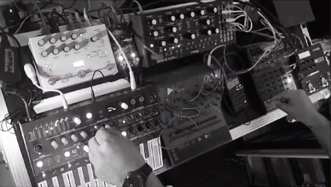 Live set from FAX, with Arturia MicroBrute, Moog, other gear in black and white still from streamed performance