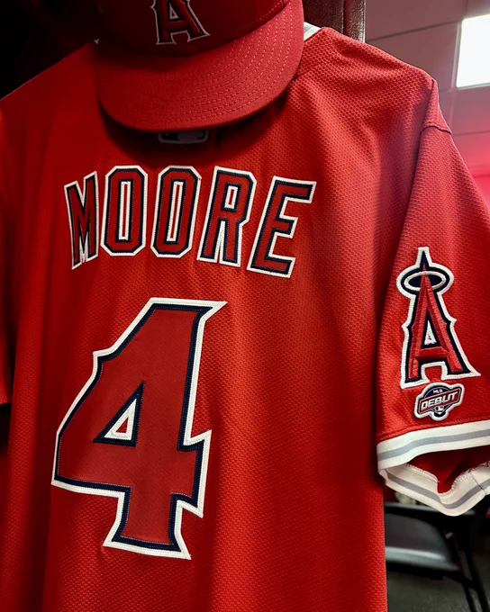 Christian Moore’s red jersey, featuring the number 4 on the back and an MLB Debut patch on the sleeve, hangs in his locker in Baltimore.