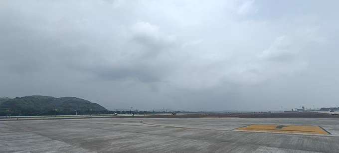 NMIA Airport Runway and taxiway and dark clouds above