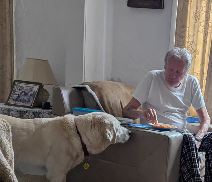 Uri being given carrots by an elderly gentleman 
