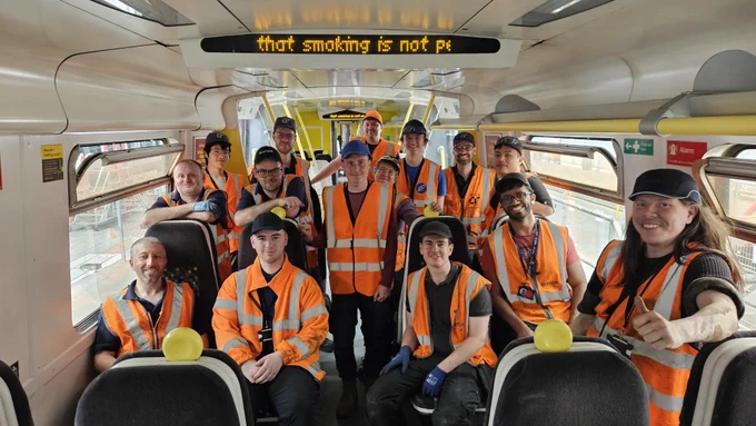 Members of the 507 preservation society and Young Rail Professionals inside the saloon of 507001.