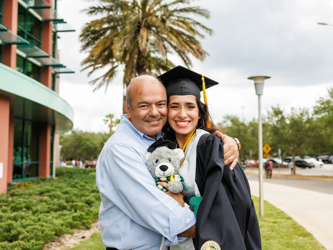 A father hugging a USF graduate