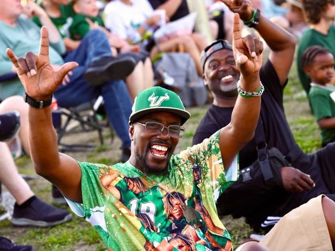 A father smiling at the USF Spring Football Game