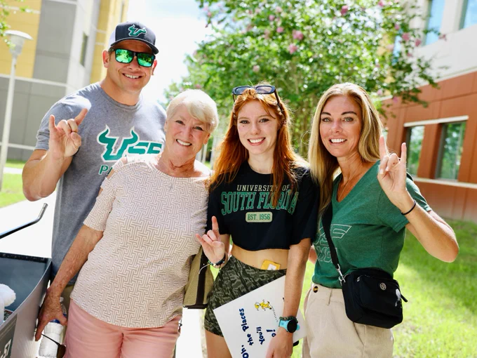 A family posing during move-in day