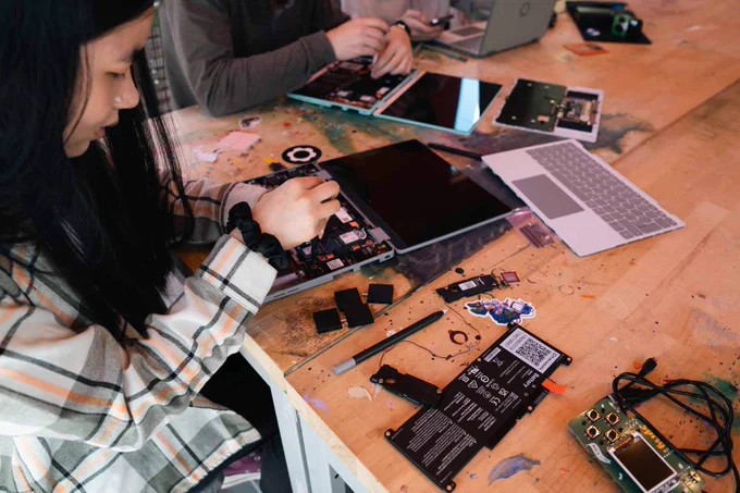 A Hack Clubber taking apart a Framework Laptop 12.