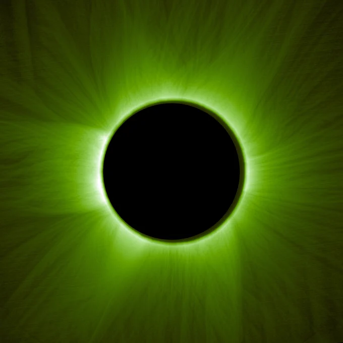 Black circle in the centre of the image showing the coronograph covering the Sun's surface. Green hair-like structures spill out from around it showing the Sun's corona.