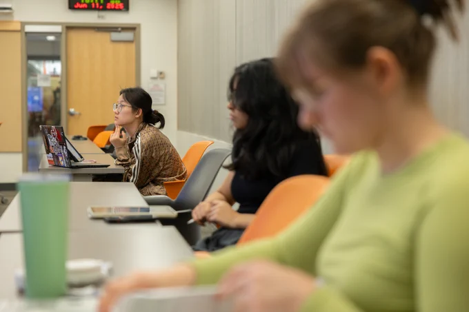 Three Virginia Tech ECE students are looking intently at collegiate assistant professor Arthur Ball teach circuits and devices.