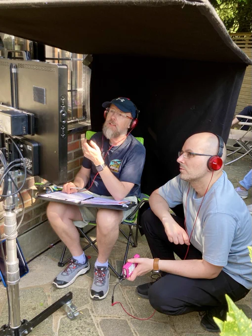 Script supervisor and director looking at a monitor.