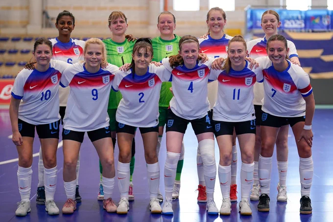England Deaf team line-up for a team photo in a futsal hall. 