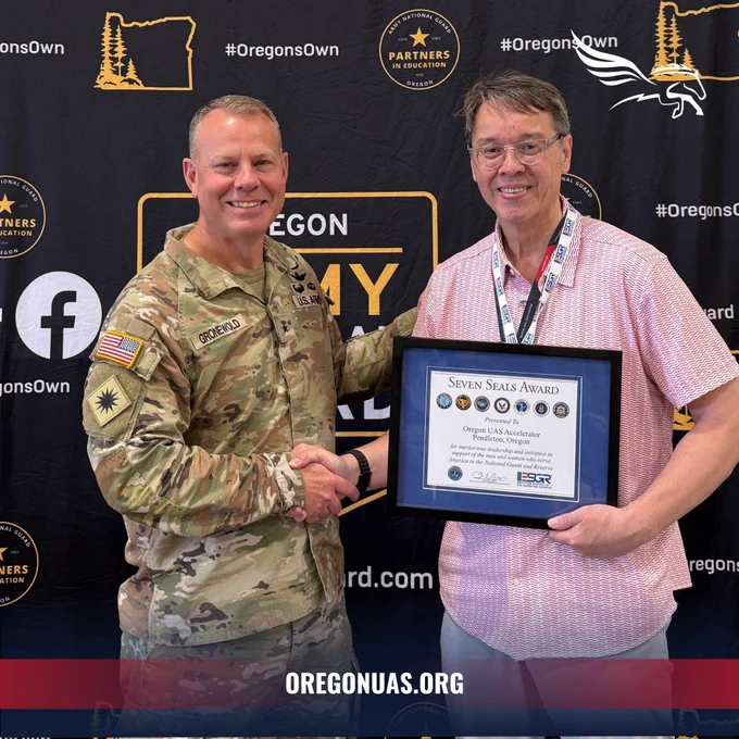 Joseph Wyno, Executive Director of the Oregon UAS Accelerator, receives the Seven Seals Award from Brigadier General Alan R. Gronewold, The Adjutant General of the Oregon National Guard, at the ORNG Labor Summit 2025.

