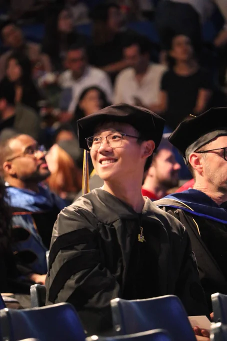 An excited graduate student taking their seat
