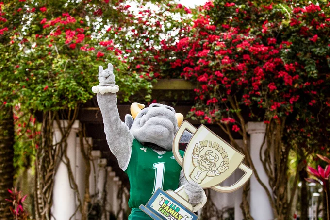 Rocky D. Bull holding a trophy and looking at the sky