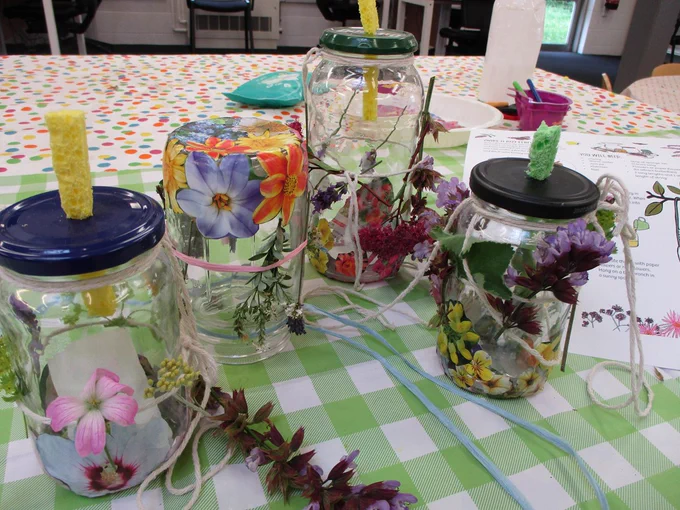 Busy hands creating butterfly feeders and planting mini meadows.