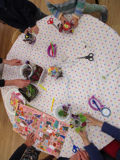 Busy hands creating butterfly feeders and planting mini meadows.