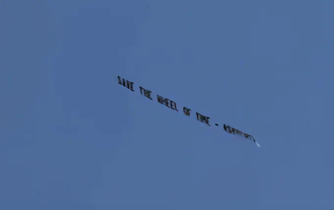 banner saying to save the wheel of time flying in the air