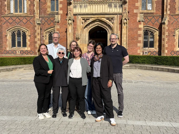a landscape picture of Juliet Dryden, Cynthia Enloe, Kyle Grayson, Juanita Elias, Eve Harrison-Taylor and QUB staff.