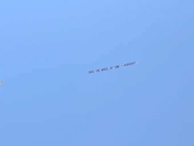 Sky banner against a blue sky that reads: Save The Wheel of Time - #SAVEWOT 