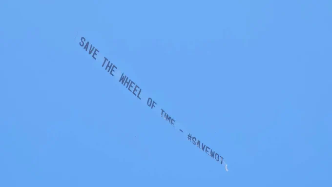 Sky banner against a blue sky that reads: Save The Wheel of Time - #SAVEWOT 